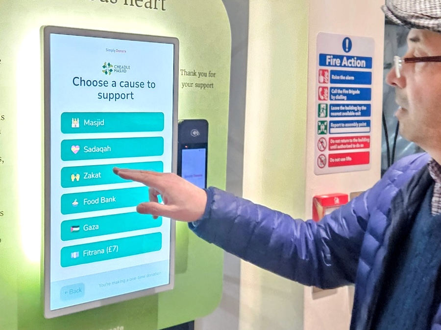 Donor choosing a campaign on a Simply Donate kiosk