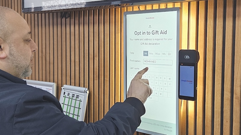Donor completing a Gift Aid opt-in on a Simply Donate kiosk